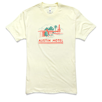 A cream t-shirt with a colorful illustration of the Austin Motel building and the text 'AUSTIN MOTEL' printed across the chest.